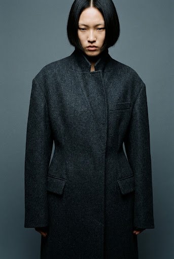 Figure in structured wool coat detail