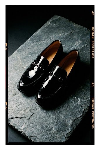 Patent leather loafers on slate